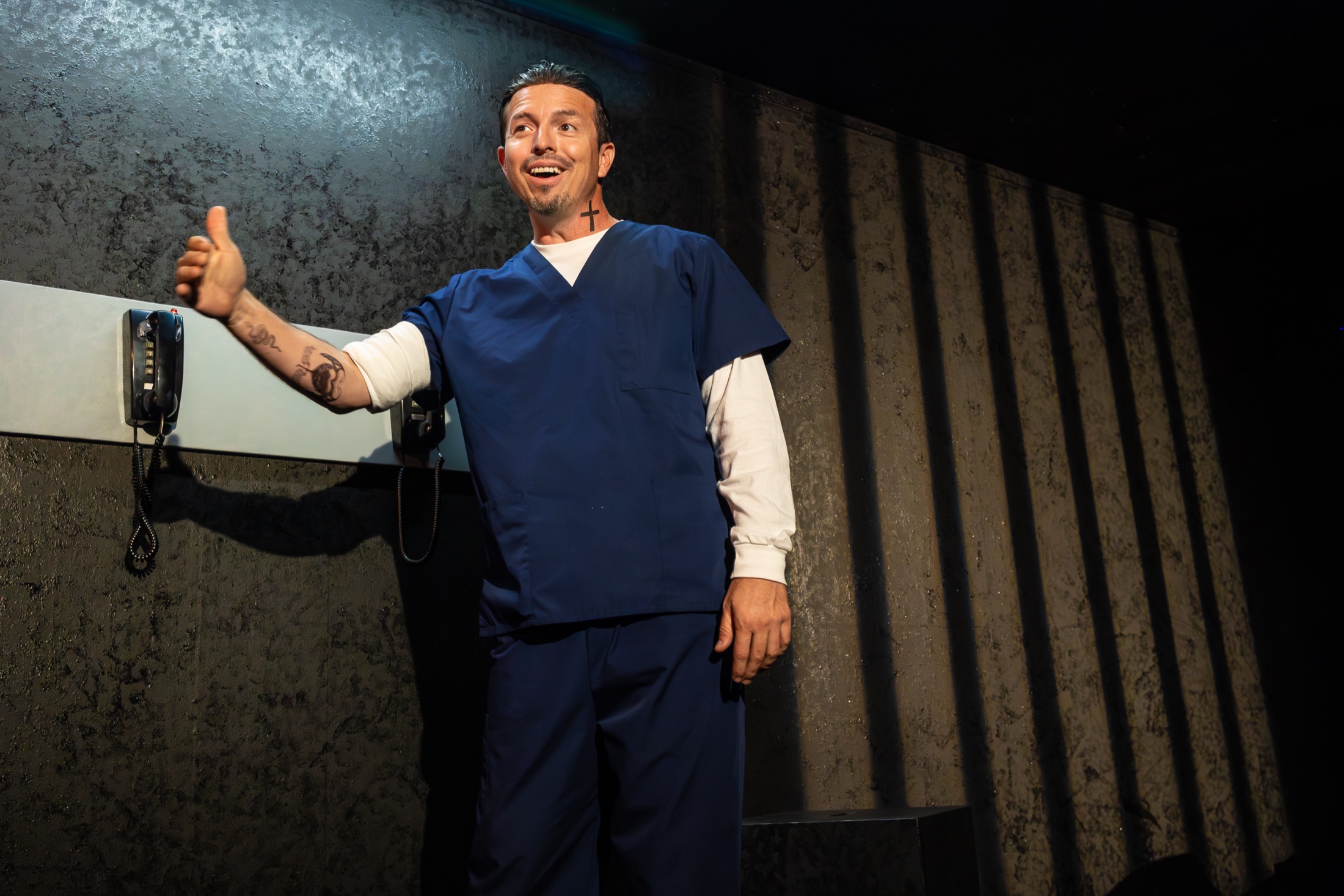 An Inside Out performer standing beside the stage telephones