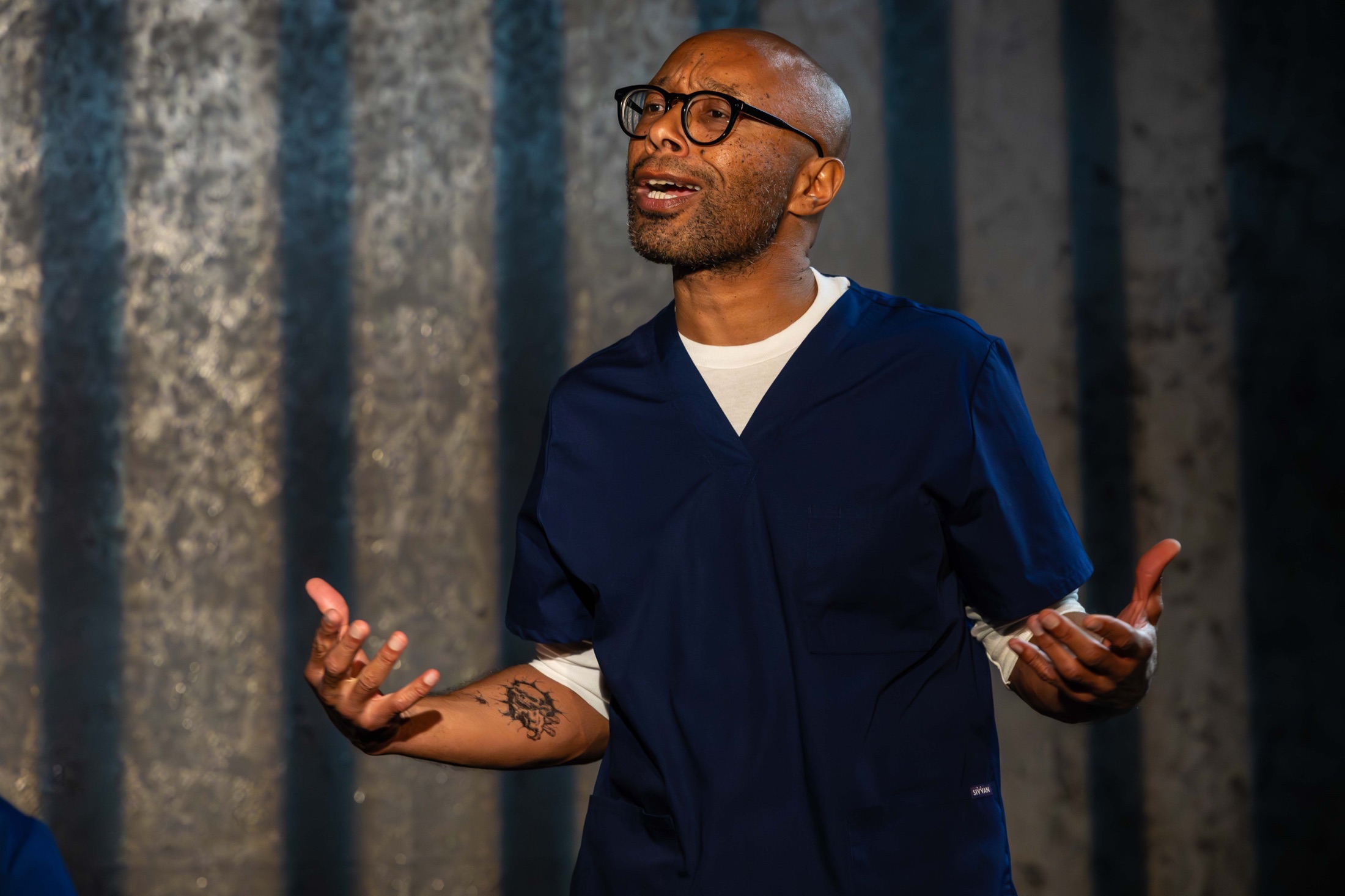 A performer speaks with open hands on the Inside Out stage